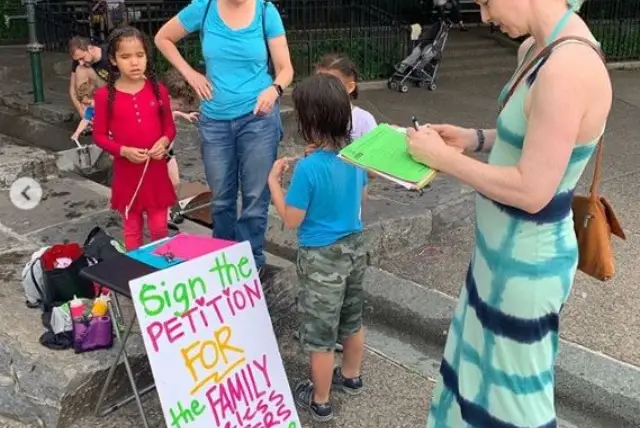 A Park Slope resident signs a petition supporting the opening of  new homeless shelters in the neighborhood.
